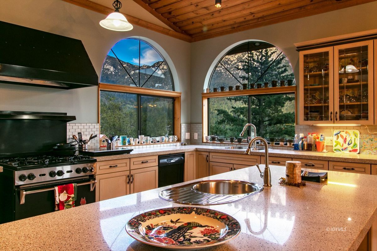 54850 Chipmunk Drive Idyllwild, CA 92549 - Photo 20 of 44 a kitchen with stainless steel appliances granite countertop a stove a sink and a microwave