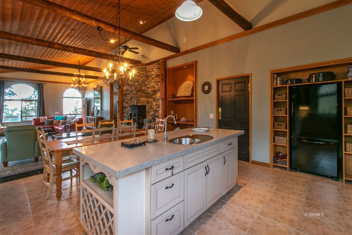54850 Chipmunk Drive Idyllwild, CA 92549 - Photo 24 of 44 a dining hall with stainless steel appliances granite countertop a sink and cabinets