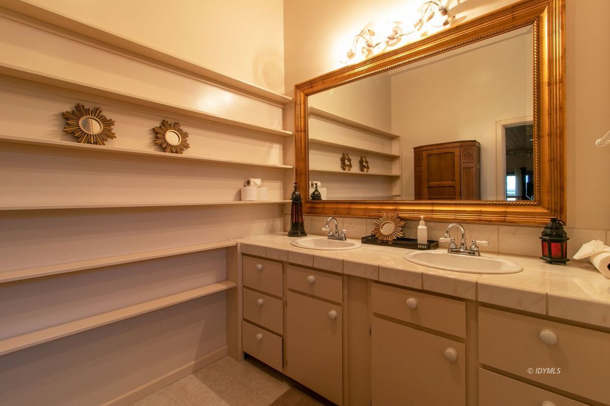 54850 Chipmunk Drive Idyllwild, CA 92549 - Photo 28 of 44 a bathroom with a double vanity sink and a mirror