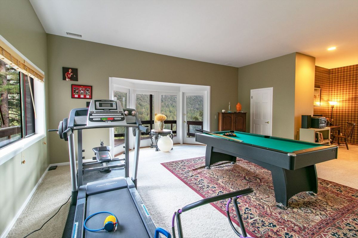 54850 Chipmunk Drive Idyllwild, CA 92549 - Photo 33 of 44 a living room with furniture a flat screen tv and a table