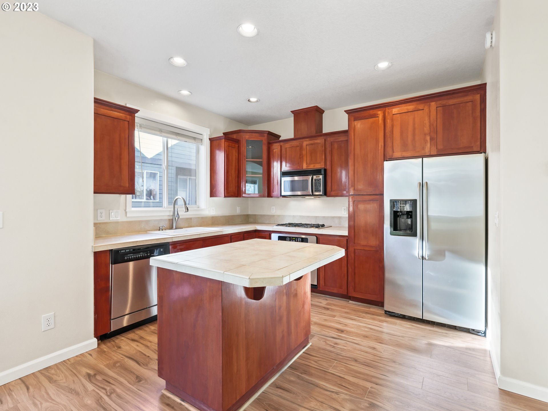 1253 Southwest 162nd Avenue Beaverton, OR 97006 - Photo 14 of 48 a kitchen with stainless steel appliances granite countertop a sink and a refrigerator