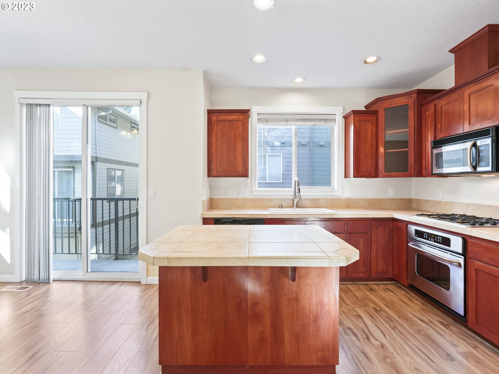 1253 Southwest 162nd Avenue Beaverton, OR 97006 - Photo 15 of 48 a kitchen with stainless steel appliances granite countertop a stove a sink and a microwave