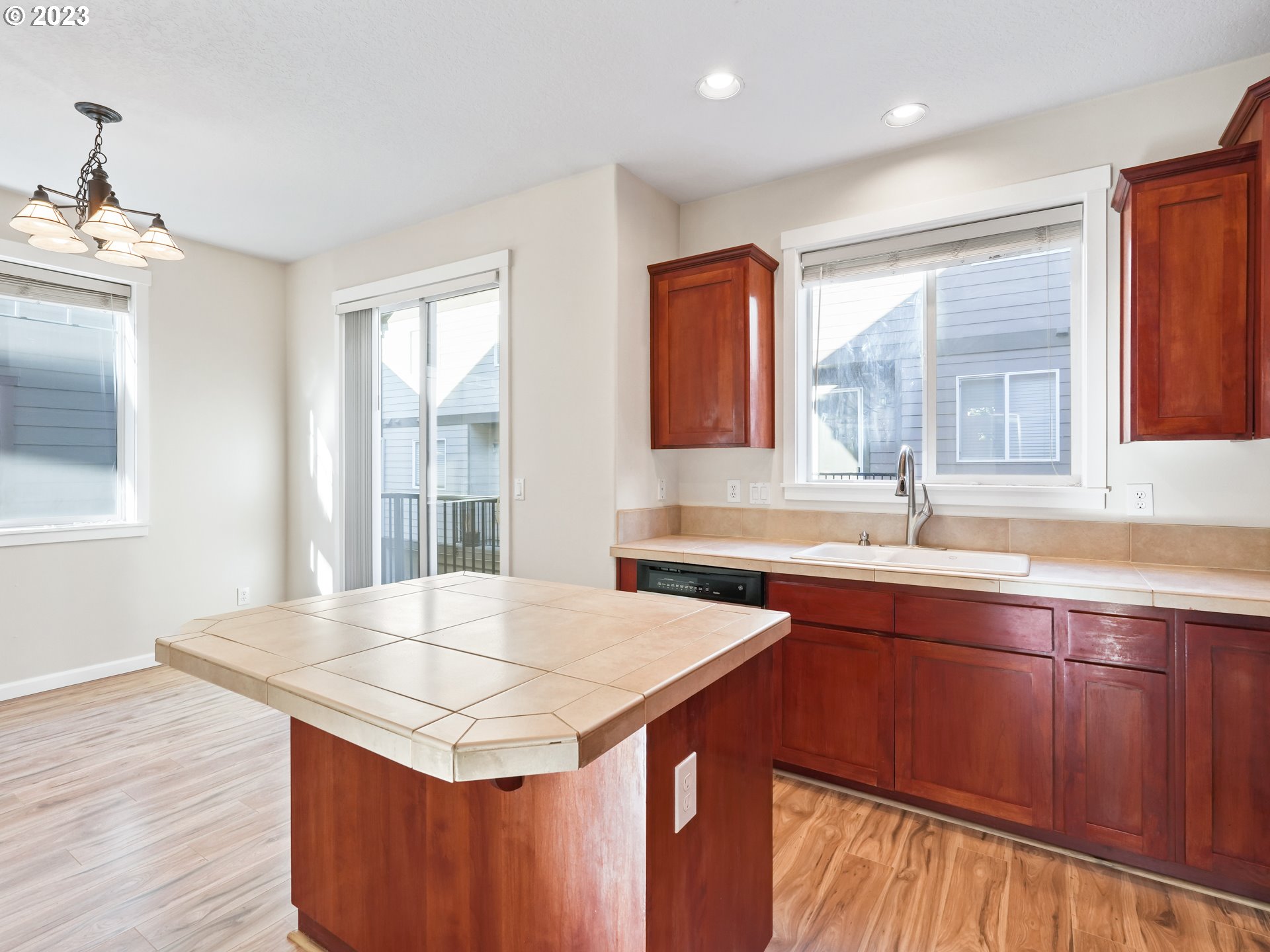 1253 Southwest 162nd Avenue Beaverton, OR 97006 - Photo 16 of 48 a kitchen with stainless steel appliances granite countertop a sink stove and wooden floor