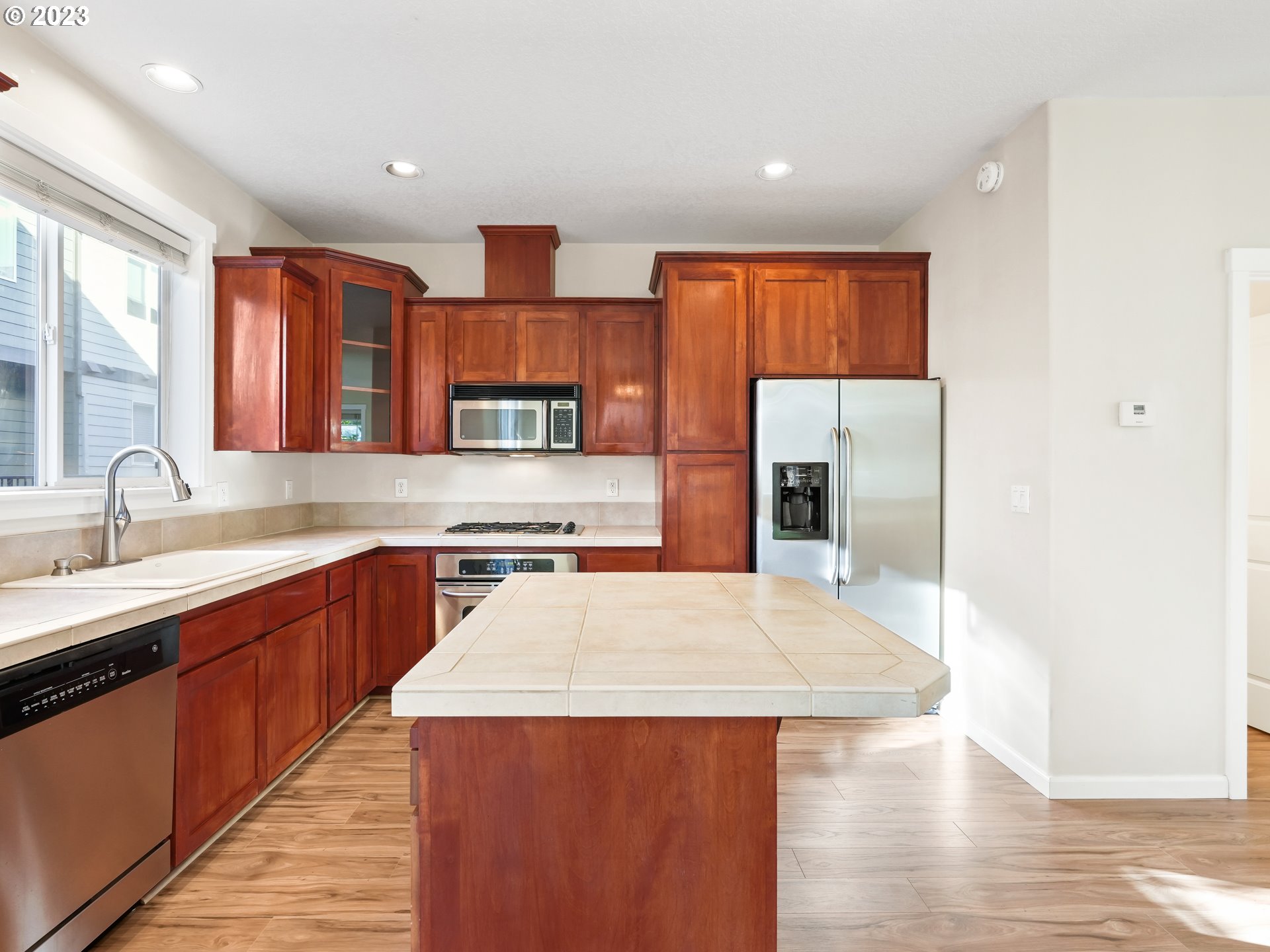 1253 Southwest 162nd Avenue Beaverton, OR 97006 - Photo 18 of 48 a kitchen with stainless steel appliances granite countertop a sink and wooden cabinets