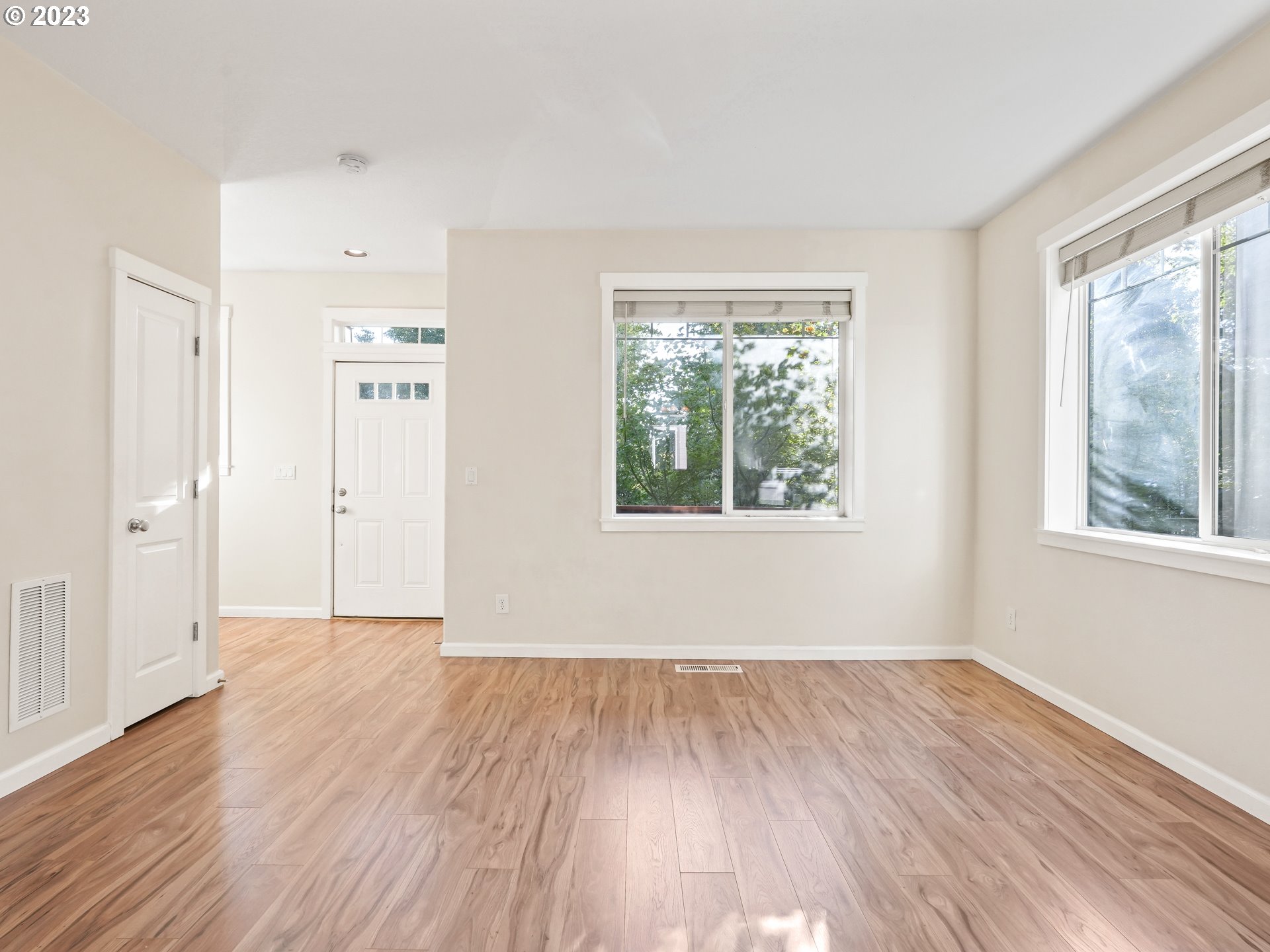 1253 Southwest 162nd Avenue Beaverton, OR 97006 - Photo 9 of 48 a view of an empty room with wooden floor and a window