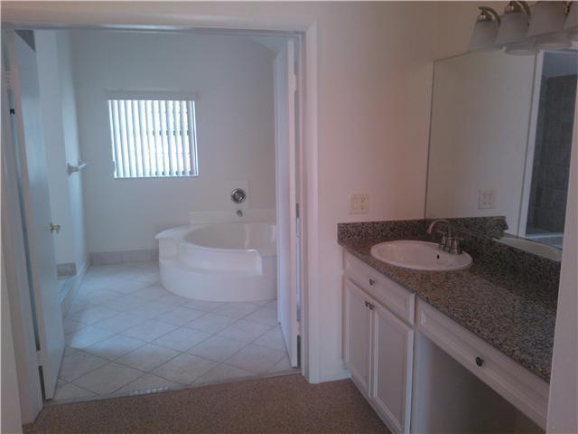 6170 Vía Tierra Boca Raton, FL 33433 - Photo 11 of 17 a bathroom with a granite countertop sink a toilet and a mirror