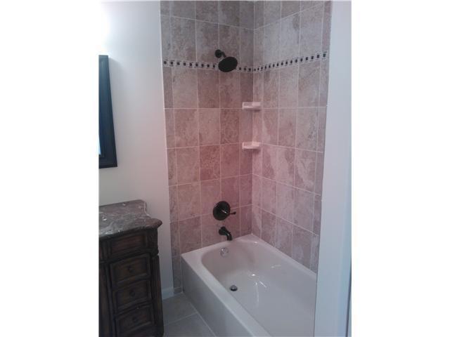 6170 Vía Tierra Boca Raton, FL 33433 - Photo 3 of 17 a bathroom with a tub shower sink vanity and a toilet