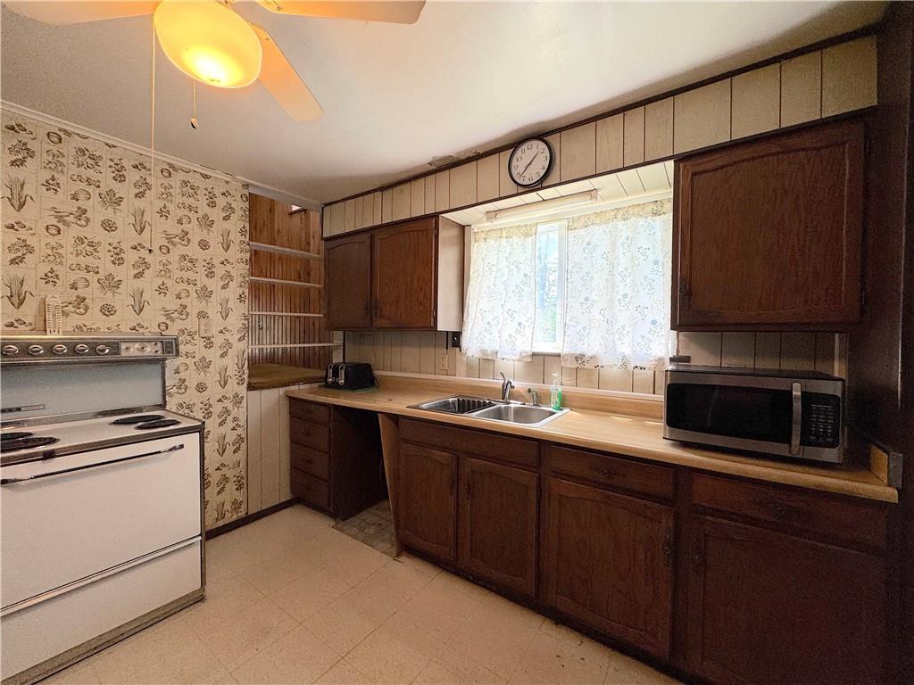 3003 Riverside Drive Claridge, PA 15623 - Photo 12 of 28 a kitchen with stainless steel appliances a stove sink and microwave