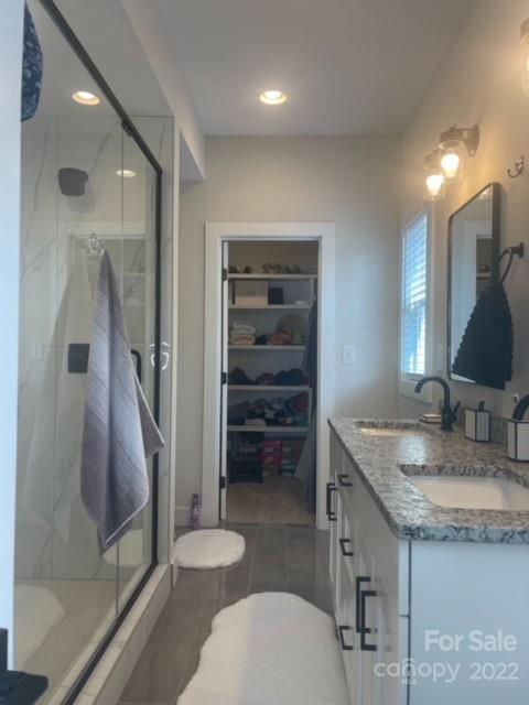 3047 Ridge Avenue Charlotte, NC 28208 - Photo 23 of 38 a bathroom with a granite countertop sink a toilet and a mirror