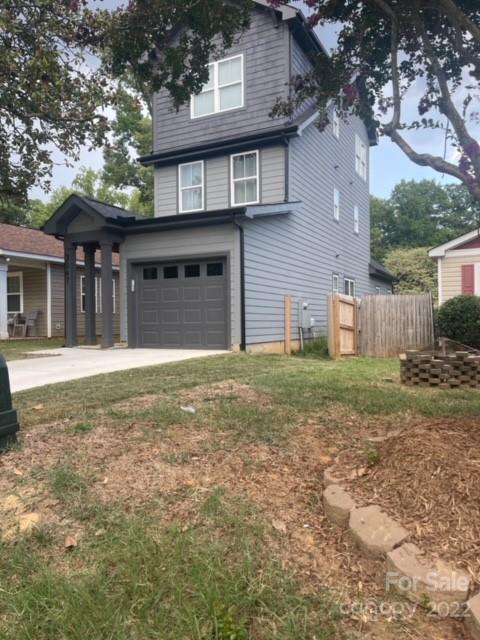 3047 Ridge Avenue Charlotte, NC 28208 - Photo 4 of 38 a front view of a house with a yard