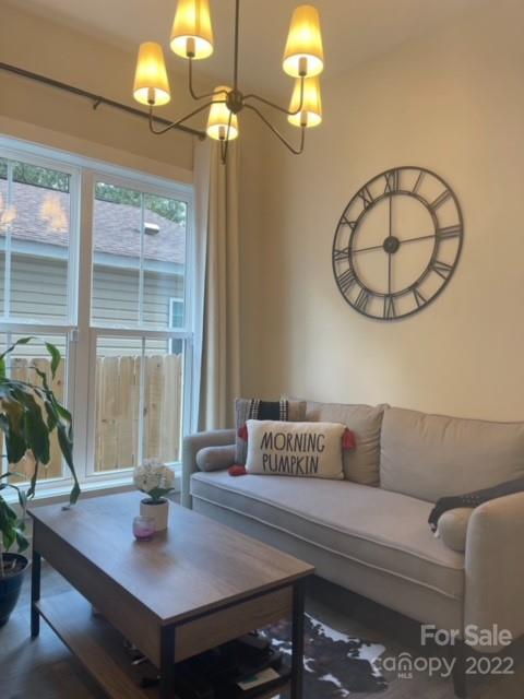 3047 Ridge Avenue Charlotte, NC 28208 - Photo 10 of 38 a living room with furniture a chandelier and a window