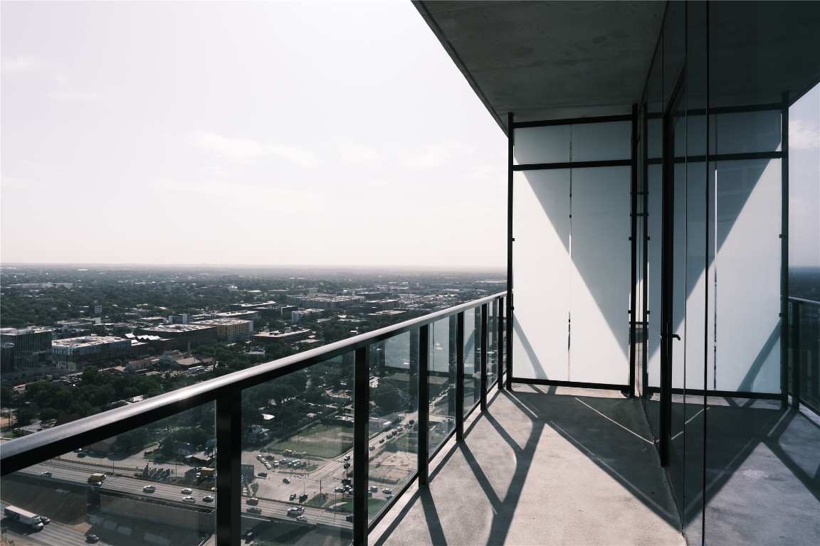 610 Davis Street, Unit 3110 Austin, TX 78701 - Photo 11 of 34 a view of balcony with wooden floor and fence