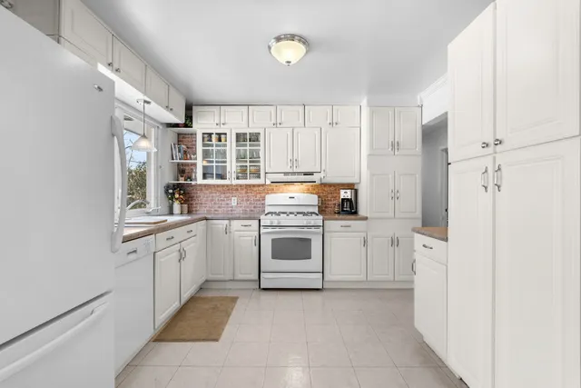 a kitchen with stainless steel appliances granite countertop a stove and a refrigerator
