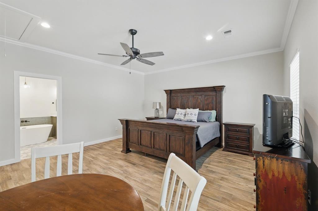 2446 Neely Trail Valley View, TX 76272 - Photo 11 of 29 a bedroom with a bed and wooden floor