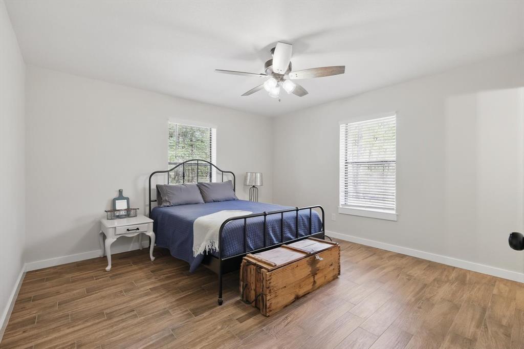 2446 Neely Trail Valley View, TX 76272 - Photo 19 of 29 a spacious bedroom with a bed and window