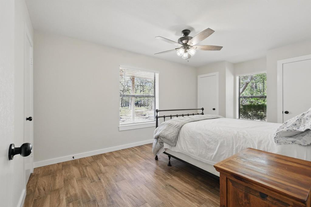 2446 Neely Trail Valley View, TX 76272 - Photo 21 of 29 a bed sitting in a bedroom next to a window