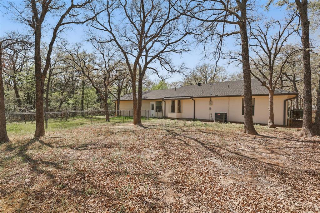 2446 Neely Trail Valley View, TX 76272 - Photo 24 of 29 a big house with trees in front of it