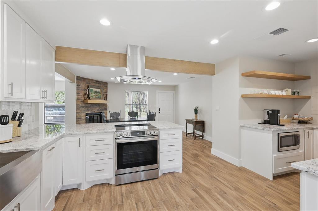 2446 Neely Trail Valley View, TX 76272 - Photo 3 of 29 a kitchen with stainless steel appliances a stove top oven and cabinets