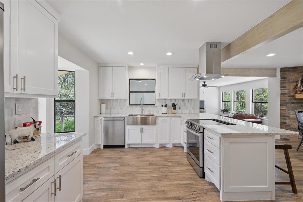 2446 Neely Trail Valley View, TX 76272 - Photo 4 of 29 a kitchen with white cabinets stove and refrigerator
