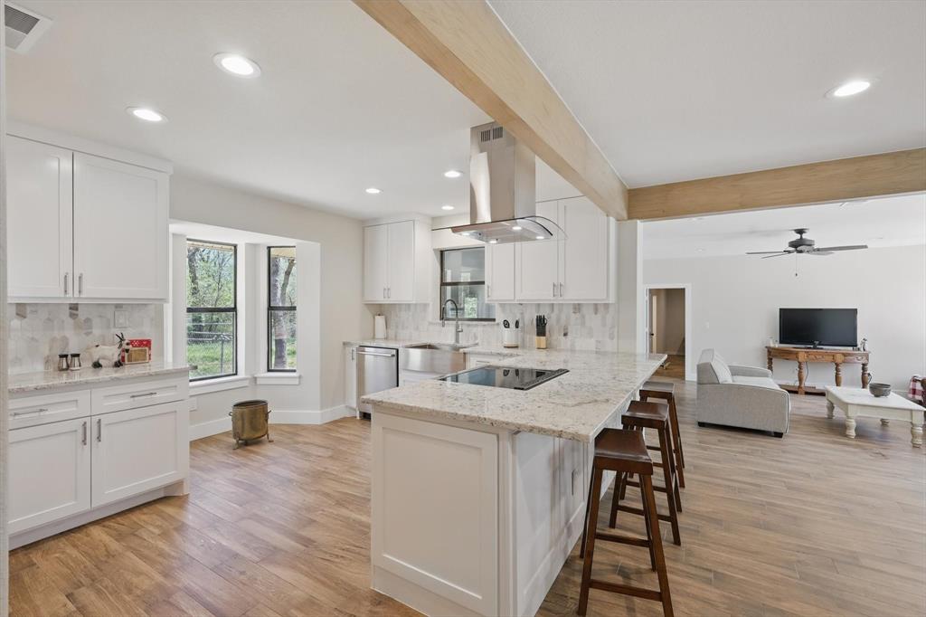 2446 Neely Trail Valley View, TX 76272 - Photo 6 of 29 a large white kitchen with sink a window and white appliances
