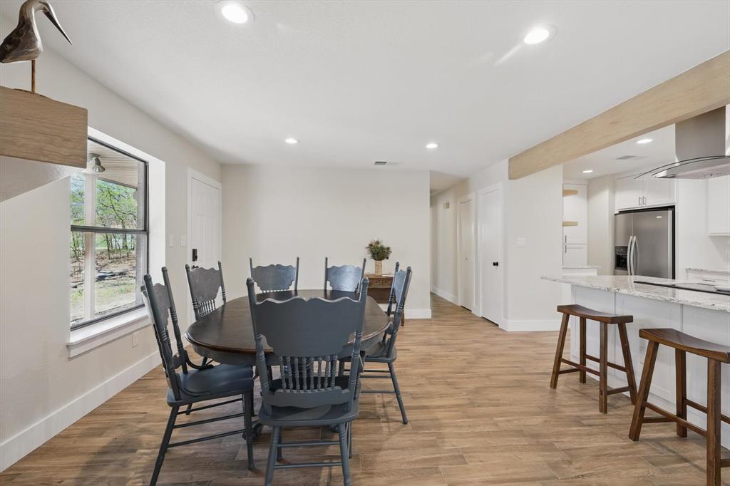 2446 Neely Trail Valley View, TX 76272 - Photo 7 of 29 a view of a dining room with furniture and wooden floor