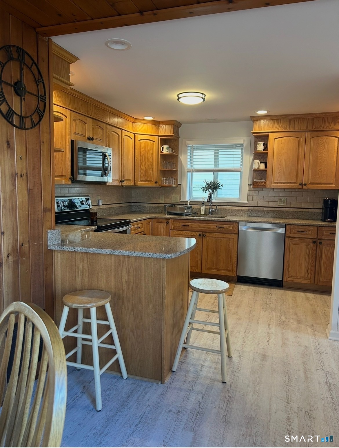 293 Giants Neck Road East Lyme, CT 06357 - Photo 7 of 21 a kitchen with stainless steel appliances granite countertop a stove a sink and a microwave