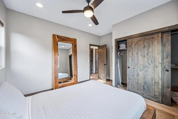 a bedroom with a bed and a chandelier