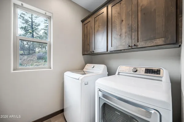 a kitchen with stainless steel appliances granite countertop a stove a sink dishwasher and a microwave oven on the wooden floor