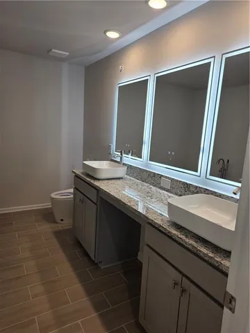 an empty room with windows and ceiling fan