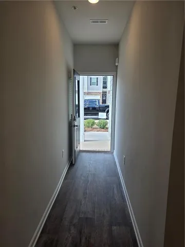 a view of hallway with wooden floor