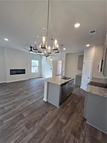 a view of a hallway with wooden floor and entryway