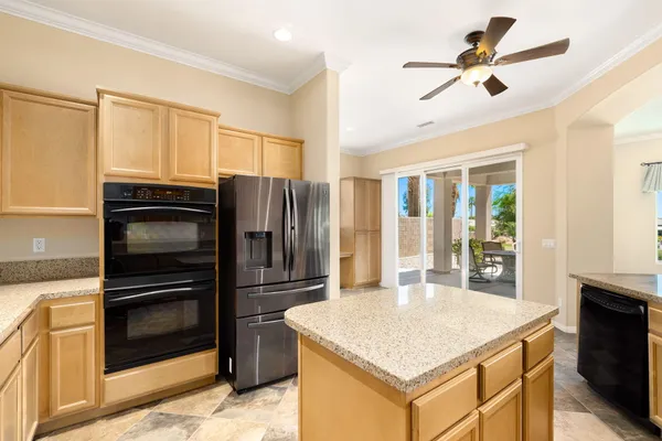 a kitchen with a refrigerator a stove a sink and a refrigerator with wooden floor