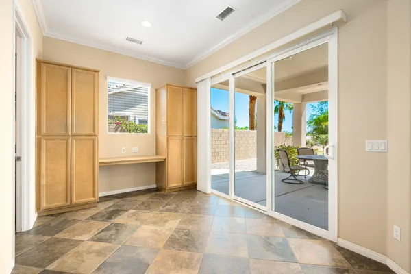 a view of an entryway with wooden floor and a livingroom