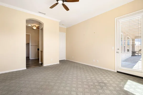 a view of a livingroom with a ceiling fan and window