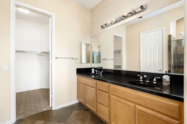 a kitchen with granite countertop a sink and a white cabinets