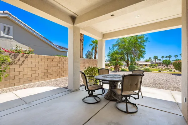 a view of a patio with table and chairs and potted plants