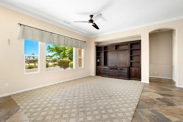an empty room with windows and cabinet