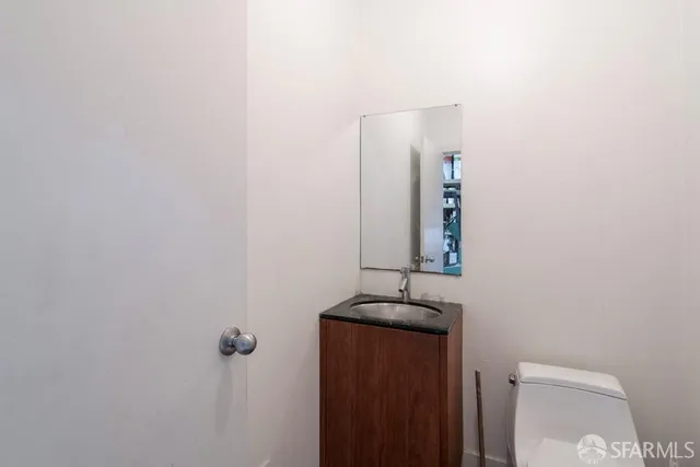 a view of a hallway with wooden floor and windows