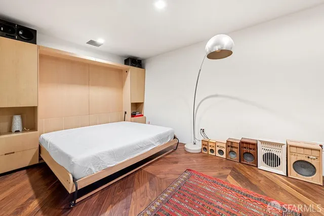 a bed room with a bed and a television