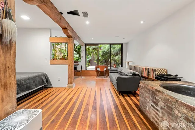a bedroom with furniture and large windows