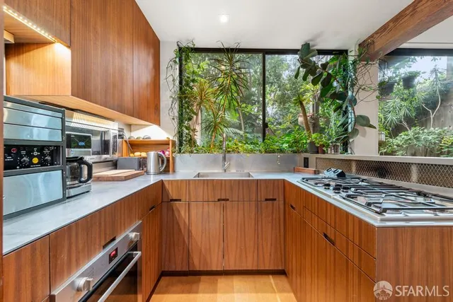 a kitchen with a stove and a large window