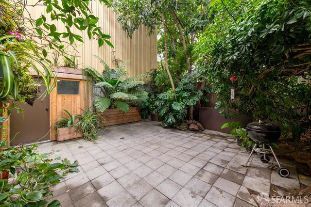 a backyard of a house with lots of green space and a fountain