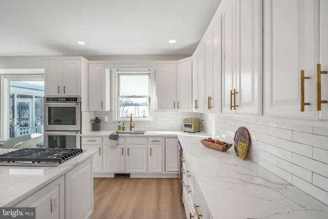 a view of a hallway with wooden floor and stairs