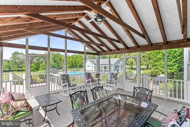 a bedroom with a bed a chair and a large window