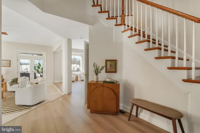 a dining room with furniture a chandelier and wooden floor