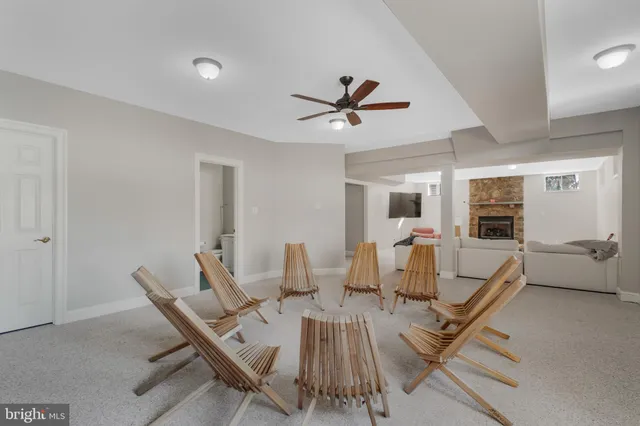 a view of a patio with table and chairs potted plants and floor to ceiling window
