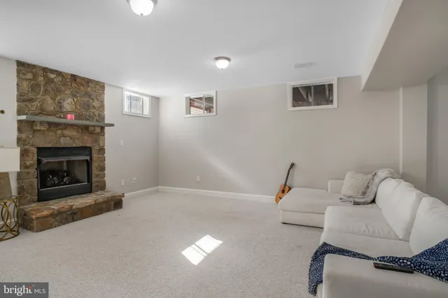 a view of a house with a floor to ceiling window and a big yard