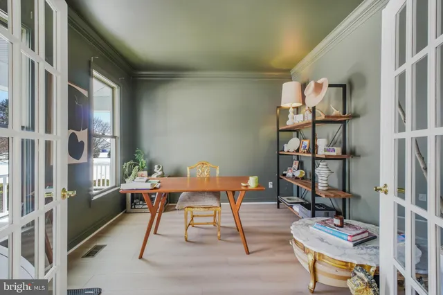 a living room with furniture a dining table and a large window