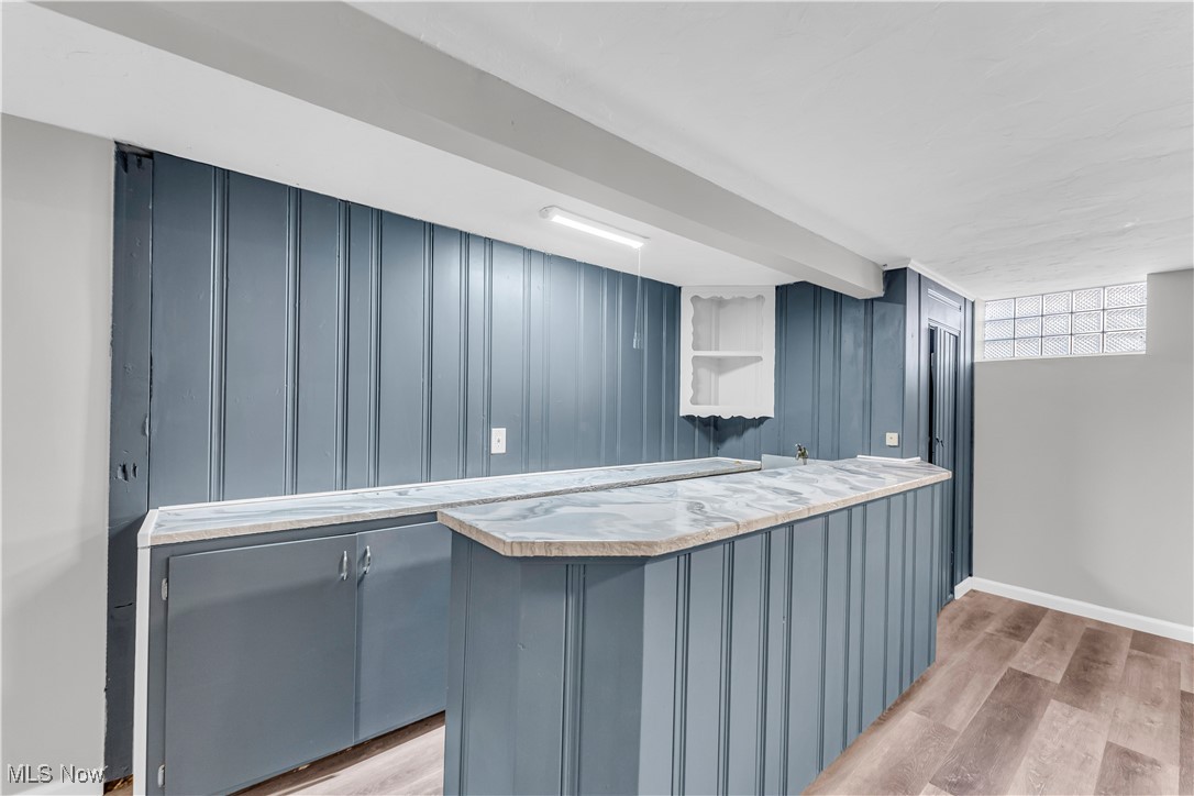 2425 Canterbury Road Cleveland Heights, OH 44118 - Photo 30 of 33 Bar with blue cabinetry and light wood-type flooring