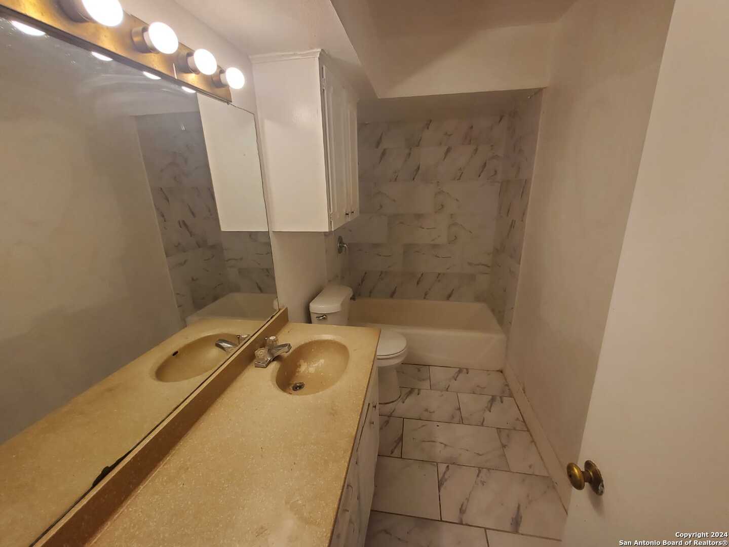 170 De Chantle Road, Unit 208 San Antonio, TX 78201 - Photo 14 of 14 a bathroom with a granite countertop sink a toilet and shower